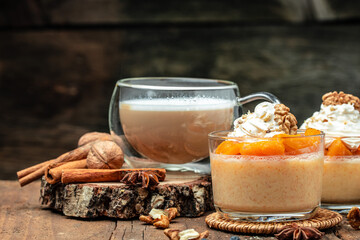 Pumpkin parfait with whipped cream, nuts in glass. Delicious breakfast or snack