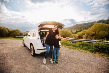 Road trip mith son. Woman with a child in summer clothes in the mountains. Couple of mother with her son on vacation. Single mom on vacation with his boy. Road trip with child	