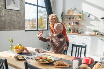 Couple looking happy and peaceful at the table in the kitchen
