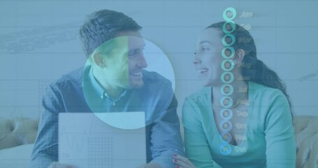 A young caucasian couple talking and paying their bills using a laptop - Powered by Adobe