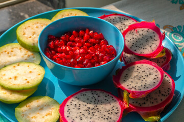 Pile of various types of fresh organic fruits (red berry strawberry, green apple, kiwi slice, orange and grapes fruit) isolated on wooden background. Healthy food boost immunity system concept.
