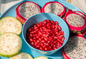 Pile of various types of fresh organic fruits (red berry strawberry, green apple, kiwi slice, orange and grapes fruit) isolated on wooden background. Healthy food boost immunity system concept.
