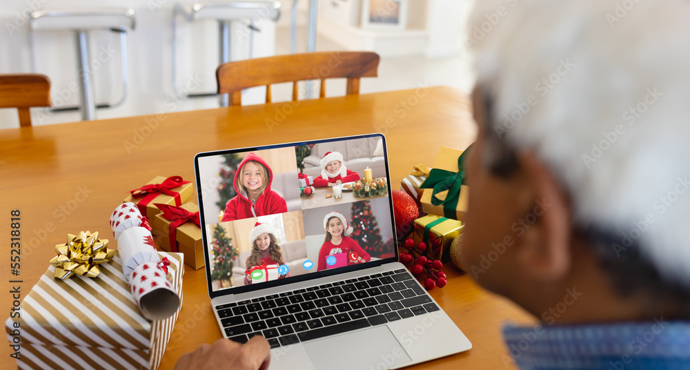 Sticker Senior biracial man having christmas video call with diverse children