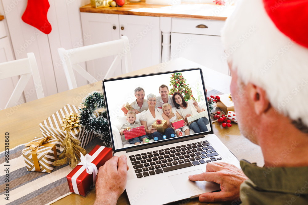 Sticker Senior caucasian man having christmas video call with caucasian family