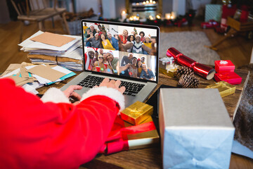 Senior caucasian man having christmas video call with diverse people