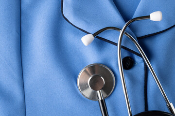 Composition of stethoscope on blue nurse's uniform shirt