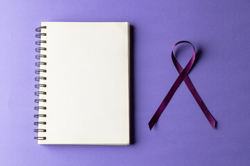 Purple add or adhd awareness ribbon and notebook with copy space, on purple background
