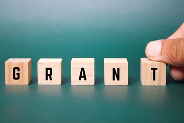 wooden cube with the word grant. Business and grant concept. the concept of giving