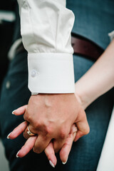 The bride and groom holding hands. Engagement.  Newlyweds of the outdoors. Close up.