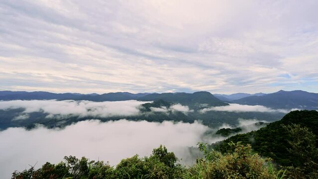 White clouds pass between the mountain tops. The beautiful sea of clouds. Feicui Reservoir, Shiding District, New Taipei City, Taiwan.