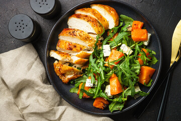 Chicken salad with pumpkin, blue cheese and arugula. Dash diet, keto diet meal. Top view image.