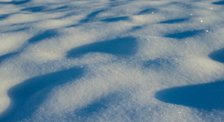 winter snow background - snow covered surface and artistic bokeh