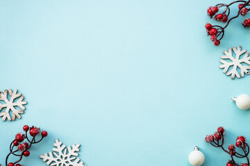 Christmas background with holiday decorations on blue. Minimal style. Flat lay image with space for design.