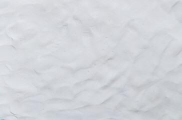 White or grey Plasticine textured background has a rough surface. By using your hand to knead it to flatten and have fingerprints attached.	
 Used is House wall for background or website wallpaper. 