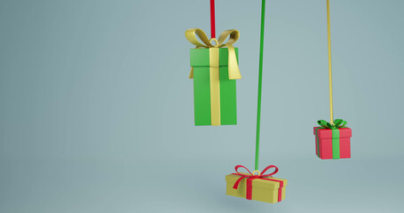 Image of three christmas presents hanging with ribbons with copy space over grey background