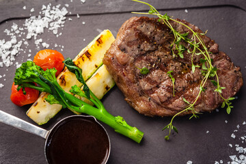 Black Angus New York steak. Marbled beef sirloin from Uruguay. Delicious healthy traditional food closeup served for lunch in modern gourmet cuisine restaurant