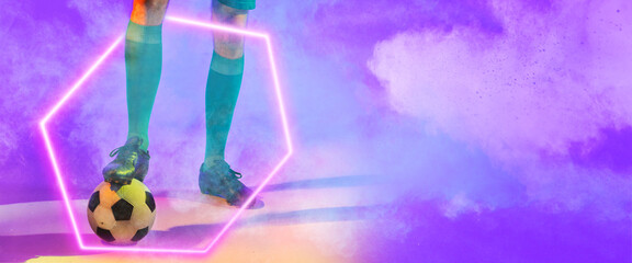 Low section of male player with leg on soccer ball over illuminated hexagon against smoke