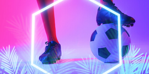 Low section of caucasian male player with leg on ball by illuminated plants and hexagon, copy space