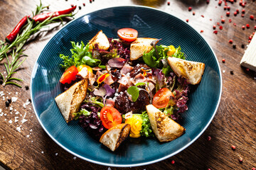 Warm chicken liver salad with port wine-honey sauce. Carrot cream, bacon, cherry tomatoes, brioche. Delicious healthy traditional food closeup served for lunch in modern gourmet cuisine restaurant