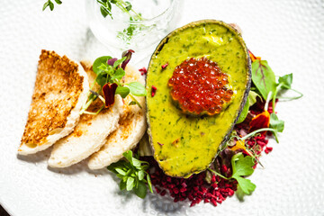 Tuna tartare. Trout roe, avocado cream, marinated onions. Delicious healthy Italian traditional food closeup served for lunch in modern gourmet cuisine restaurant