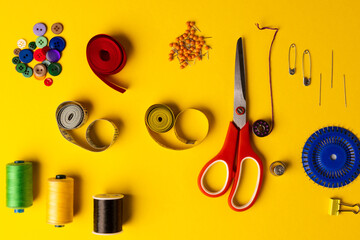 Composition of sewing equipment on yellow background with copy space