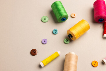 Composition of sewing equipment on beige background with copy space
