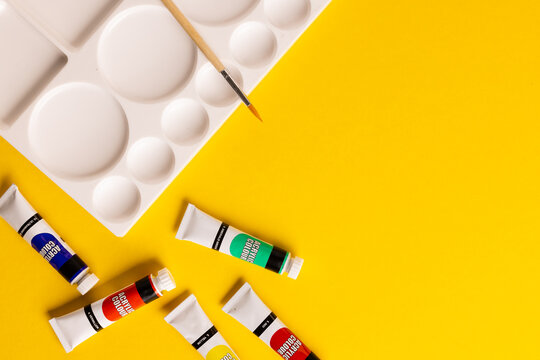 Composition of painting equipment on yellow background with copy space