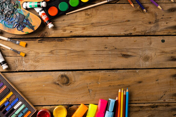 Composition of painting equipment on wooden background
