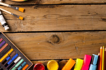 Composition of painting equipment on wooden background