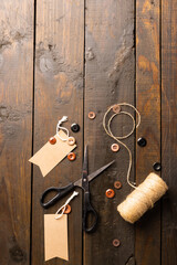 Composition of sewing equipment on wooden background