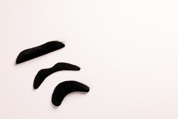 Composition of fake moustaches on white background with copy space