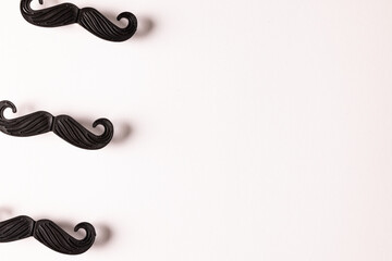 Composition of fake moustaches on white background with copy space
