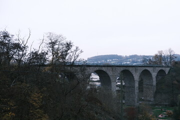 Fototapeta na wymiar Viaduct in the countryside, gray very landscape, lack of sun