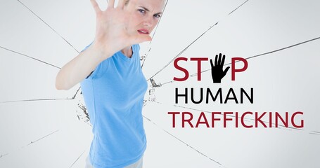 Composite of stop human trafficking text over caucasian woman showing stop sign against broken glass