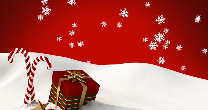 Image of snow falling over candy canes and christmas present on red background