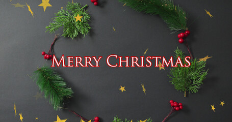Merry christmas text banner and star icons against christmas decorative items on grey surface