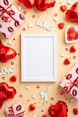 Valentine's Day concept. Top view vertical photo of photo frame gift boxes heart shaped balloons candies inscription love cupid silhouette confetti on isolated pastel beige background with blank space