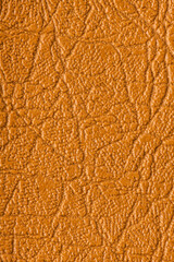 Brown artificial or synthetic leather background with neat texture and copy space