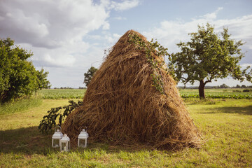 a pile of straw with lanterns
