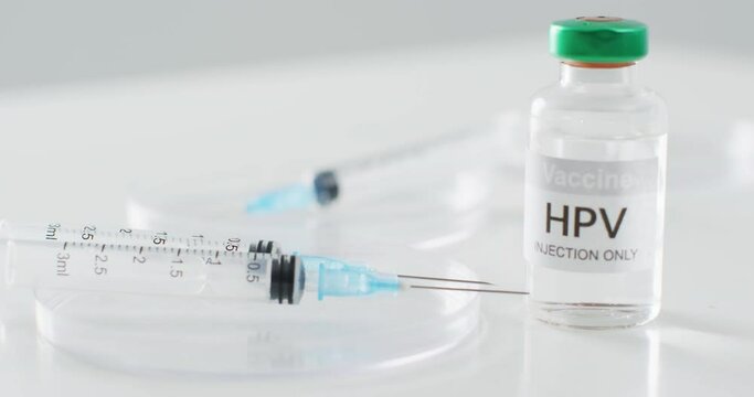 Video close up of hpv vaccine vial and syringes, with copy space
