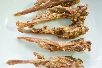 deep fried duck beak with white sesame dipping chili and black sweet soy sauce on plate