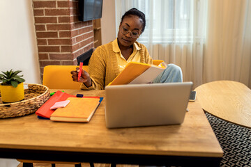 Young African American female student studying at home.