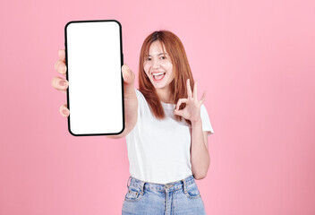 Asian young woman showing smart phone with blank screen , white screen for Mobile App Advertising...