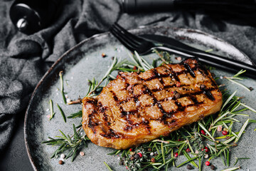 portion of juicy grilled beef steak with peppercorns