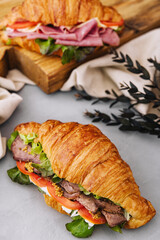 croissant with boiled pork and tomatoes