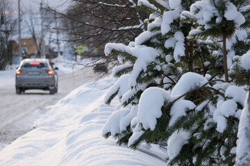 The car is driving on a snowy road
