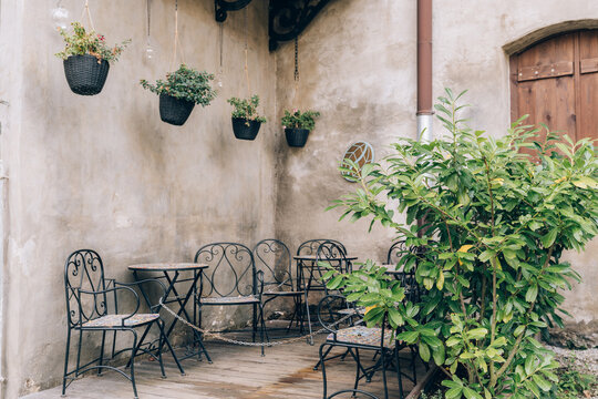 Cafe terrace with hanging plants and cozy atmosphere
