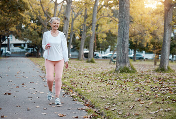 Health, nature and senior woman on walk in the morning for exercise, wellness and fitness in park....