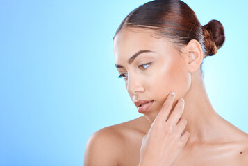 Naklejka premium Beauty, woman and skincare for a cosmetic treatment on a blue studio background for health. Dermatology, skin care and female with facial wellness aesthetic on a mockup or copyspace backdrop