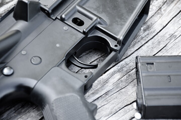 BB gun or airsoft gun muzzle and white bullets on wooden plank, soft and selective focus.